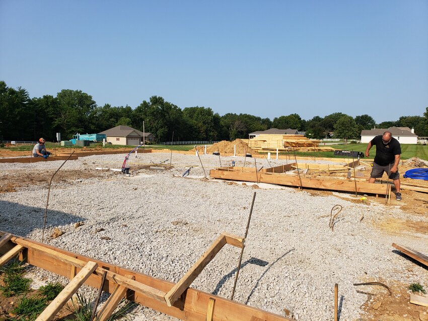 A HUB OF ACTIVITY, Clinton’s Jamestown subdivision is the site for multiple new homes where Brett Hastie checked measurements on one of three homes his company is building. However, a shortage of affordable housing in Clinton and Henry County remains as it does with many areas of the country.