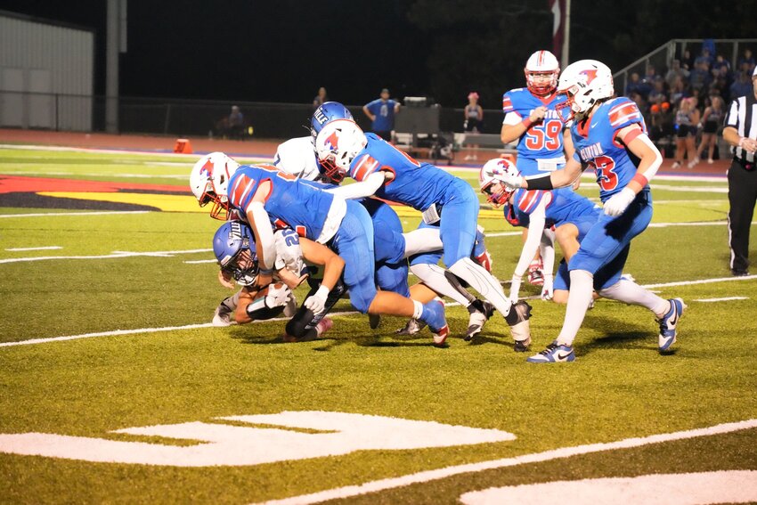 THE CARDINALS FLOCKED to the Harrisonville ball carrier to take him down in the Homecoming game on Friday. Clinton lost, 12-0 to fall to 1-6 on the season.