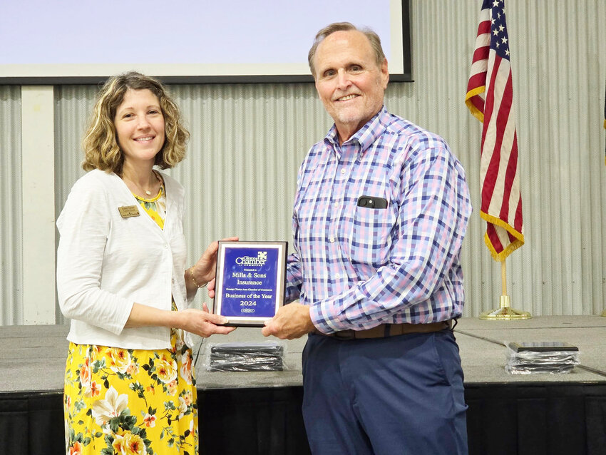 BRINGING HOME BUSINESS OF THE YEAR, Mitchell Mills and his firm Mills & Sons Insurance were recognized during the annual Clinton Chamber of Commerce Banquet. Mills was presented an award by 2024 Board President Amber Hansen.