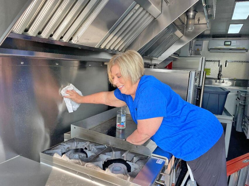 FINISHING THE MISSION, Warsaw resident Chris Riley joined volunteers from around the country to help those affected by the massive storm that hit on May 19. Riley cleaned the Quick Response Unit that houses a kitchen to feed folks in need.
