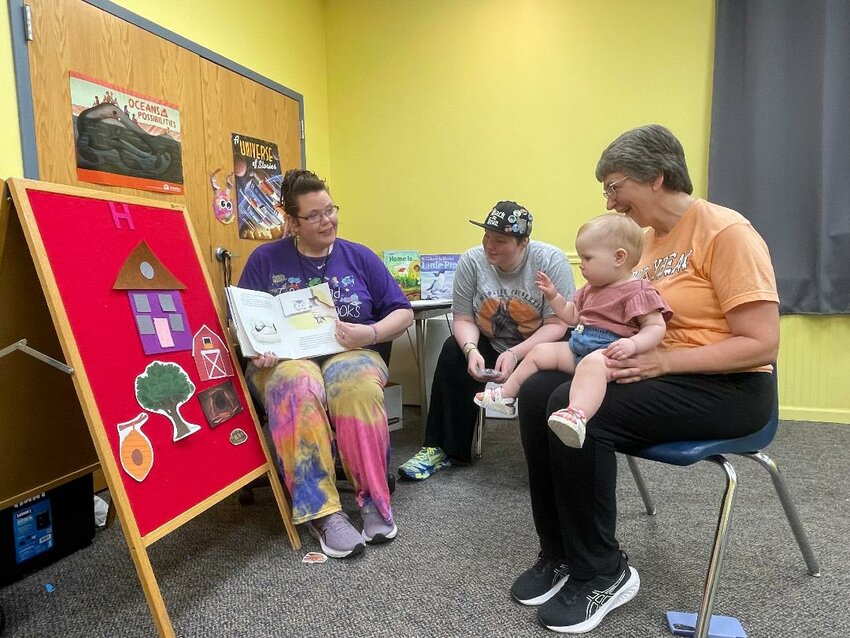 AN EXCITING SUMMER IS IN STORE for Warsaw and Cole Camp library patrons. Diane Brockman and her granddaughter Eleanor Reedy attended Story Hour at Cole Camp on Tuesday. The program is under the direction of Darla and Lillie Gottschalk.