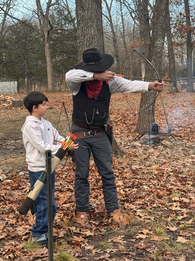 TEACHING THE WHIPPERSNAPPERS how to shoot a long bow is one role of Henry James Bonney at Kumberland Gap's scheduled Mountain Man Rendezvous.