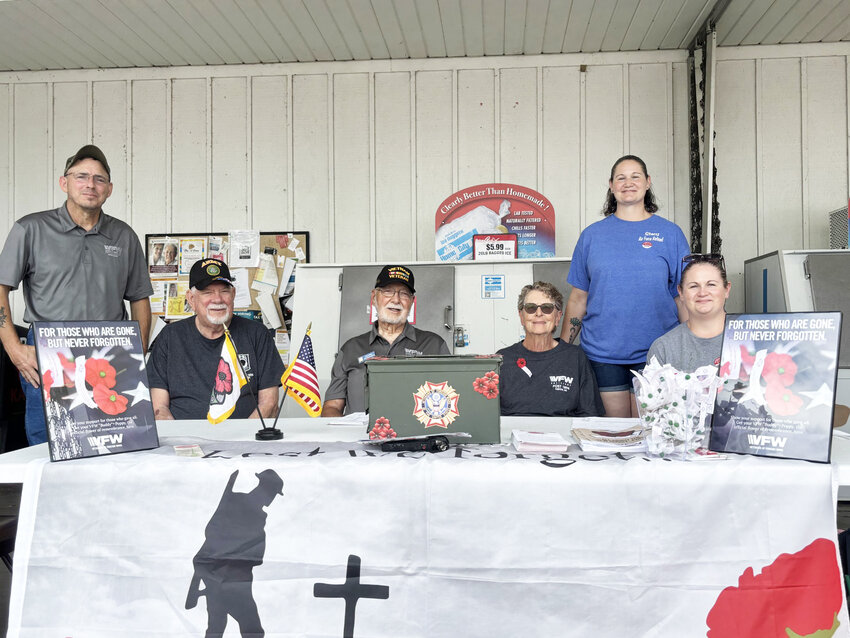 A SYMBOL OF REMEMBRANCE & SUPPORT,  Garry May, Senior Vice Commander of the VFW Post 1894, Bob Harell, trustee with the VFW Post, Bob Arnett, Junior Vice Commander, Darlene Arnett, member of the VFW Auxiliary, Stacy Powell, trustee with the post, and Jennifer Henry, member of the VFW Auxiliary, took part in the VFW Poppy Drive on Friday at Price Cutter in Clinton.