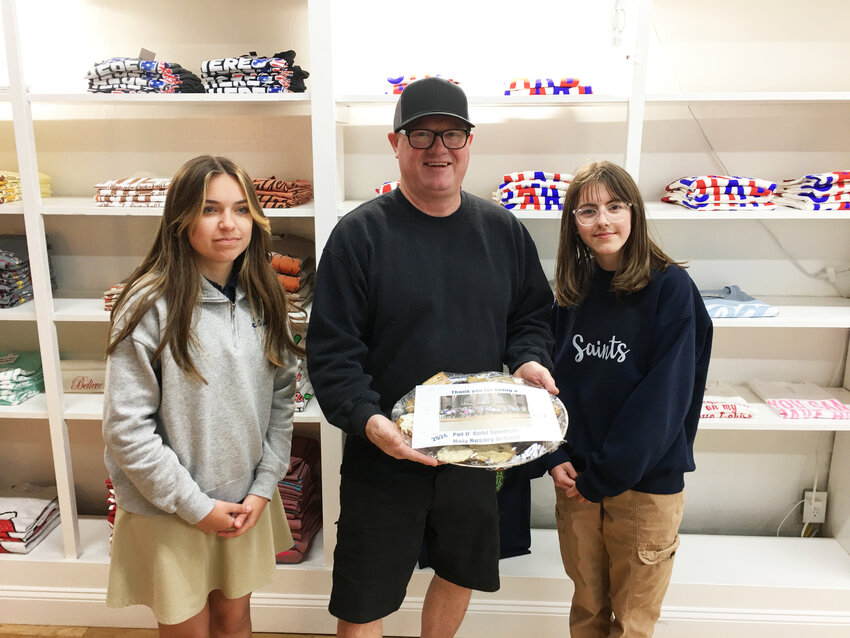 Saying ‘Thank you for your support’, Isabella Beck and Elizabeth Clubb from Holy Rosary School, stopped by with a platter of cookies. With the girls is the CDD Sales Director, Mac Vorce.