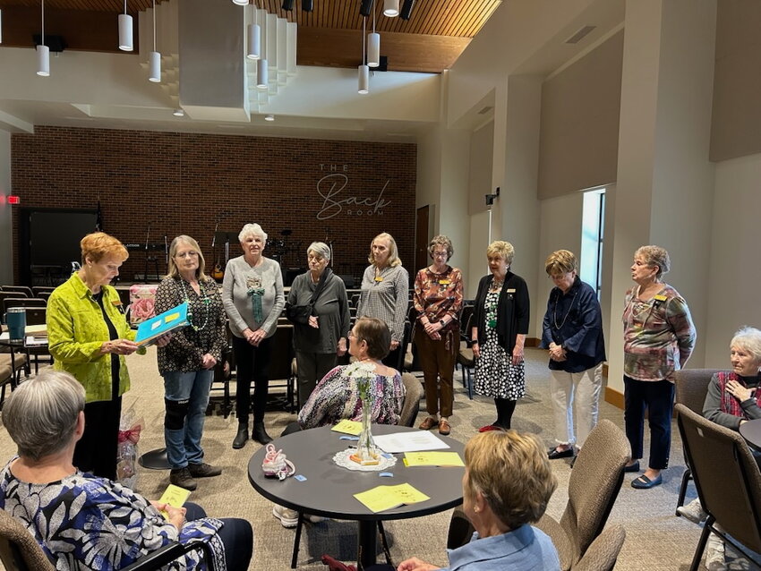 Installing the new officers of Chapter EN: Pat Brock, standing left, Mary Lou Philpott, president, Linda T. Wilson, vice-president, Sandy Wagoner, recording secretary, Sunny Johnson, corresponding secretary, Connie Grisier and Shirley Jordan, treasurers, Judy Doll, chaplain, and Marge Beasley, guard.