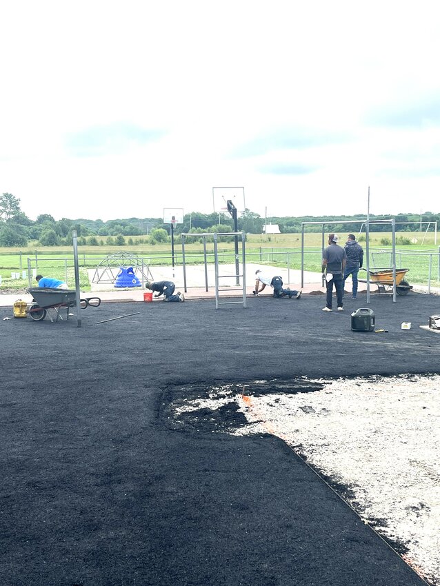 Crew from Taylormade Co. installing new pour-in-place surfacing at CCA.