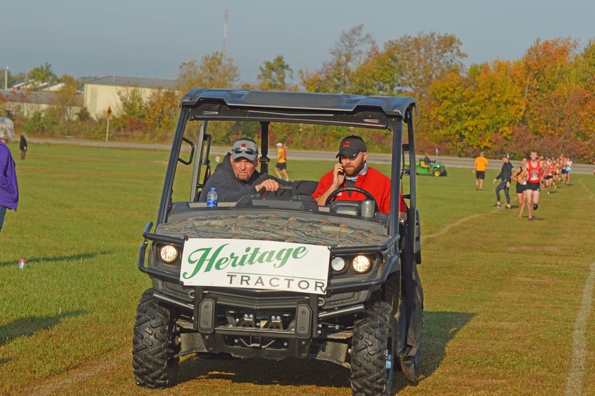 Athletic Director Jason Abner driving a &lsquo;gator&rsquo; with an area coach. They were helping with the annual Clinton Invitational Cross Country Meet. Mr. Abner is leaving the Clinton SD after ten years.
