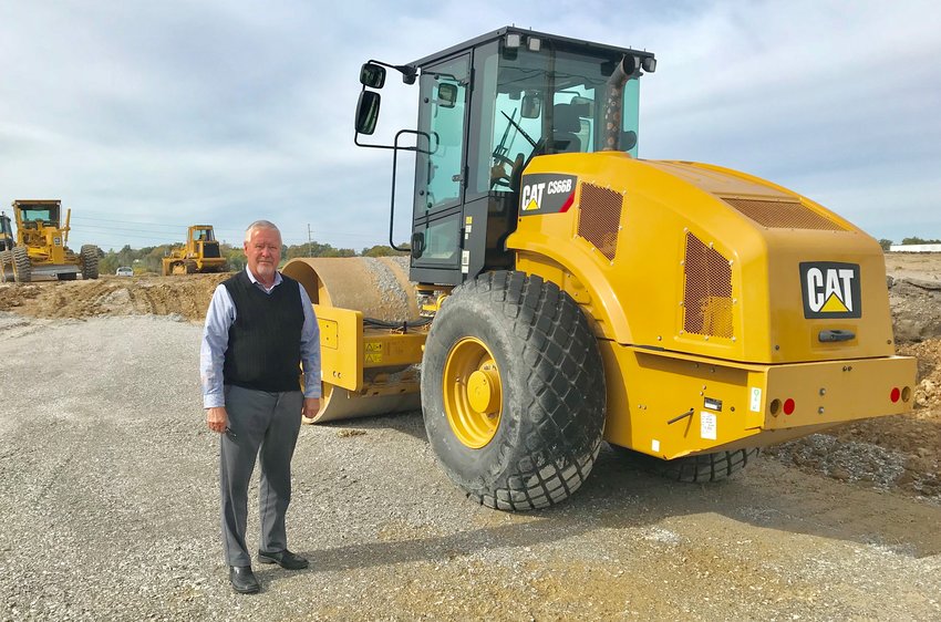 MARK DAWSON, Clinton's Economic Development Director, stands beside heavy equipment on November 1 at the North Intersection Project.