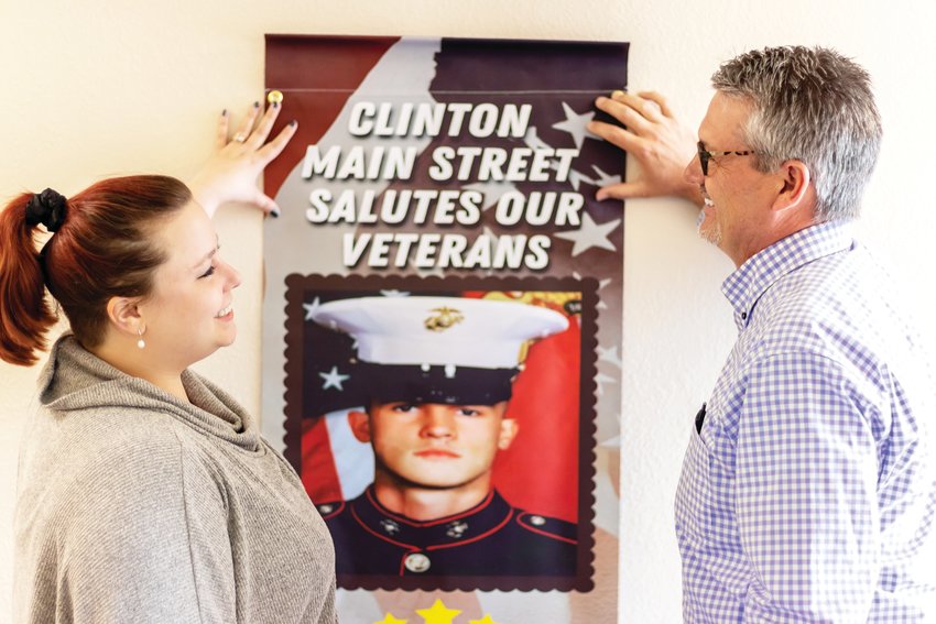 MAGNIFICENT AND NEW banners honoring area veterans have been placed around the Clinton Square. Main Street Executive Director Tina Williams and Main Street Design Director Allen Huff previewed them before they were placed.
