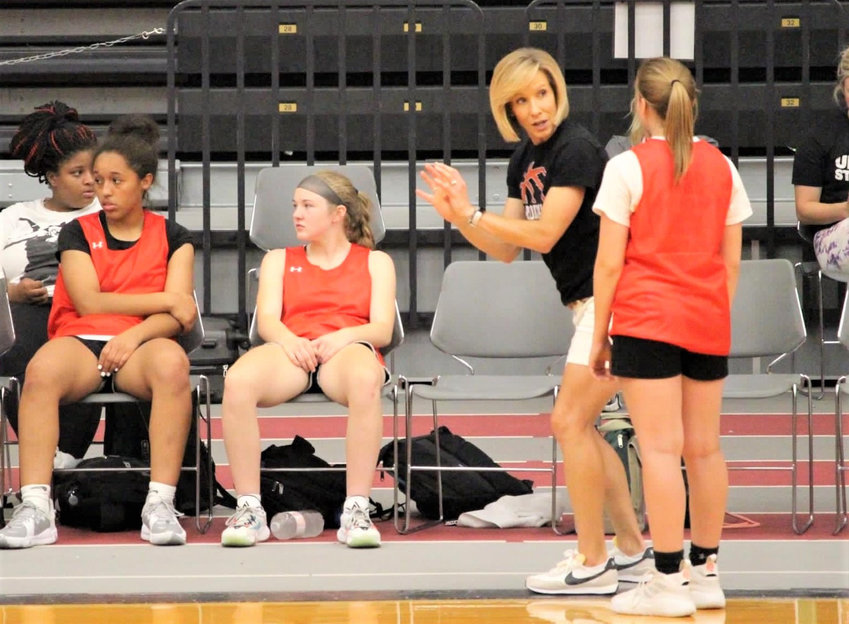 CLINTON'S Coach Womack at the UCM Team Camp working with Allie Goucher. On bench, Mercedes Brown and Hannah Campbell.