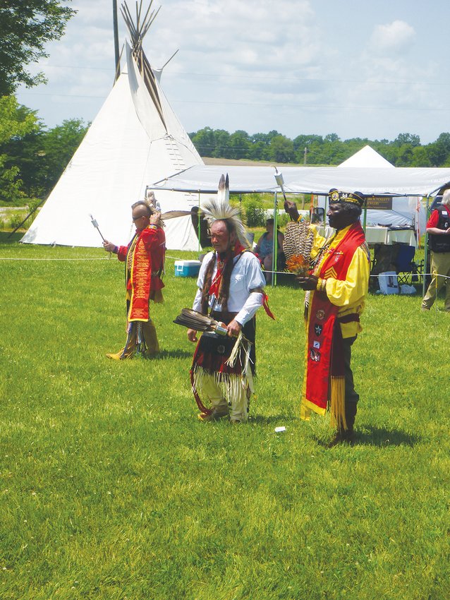 BRINGING THE PAST ALIVE, Deputy Chief of the Northern Cherokee tribe; Daniel White Crow, Head Gourd Dancer, Jim Binkley; and Eagle Warrior, Abraham Clark raised their rattles during the first set of the Gourd Dance.