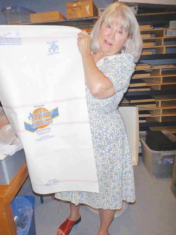 MODELING a dress made of flour sacks, Marilynn Henry addressed the Windsor Historical Society.