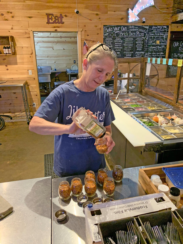 BACK IN THE WORKFORCE, Alison Gordon is part of the staff at Primitive Olde Crow Winery. Gordon  prepares condiments for their well known brick oven pizzas as part of her duties.