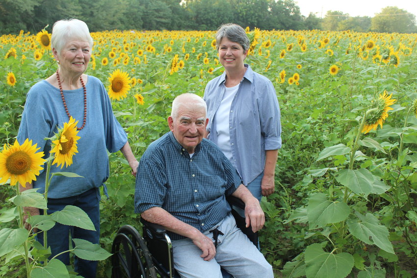 The Hinton family, Carol, Chuck and daughter Jennifer, invite people to enjoy the four acres of sunflowers they grow on the family farm on the east edge of Clinton.