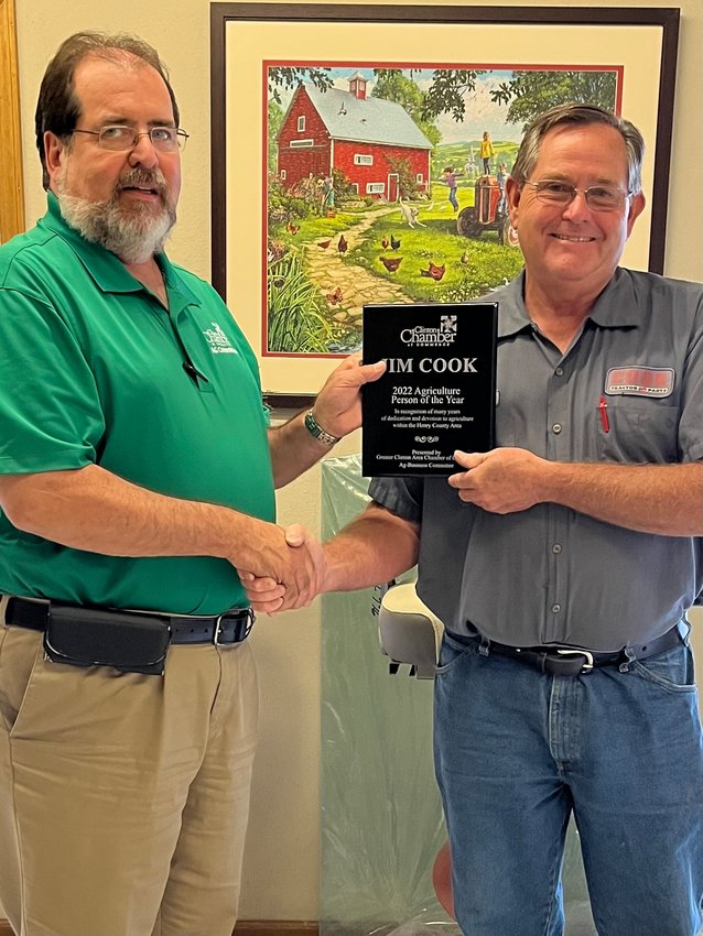 Ag Business Person of the Year,  Jim Cook, accepts plaque from Dan Wallace.