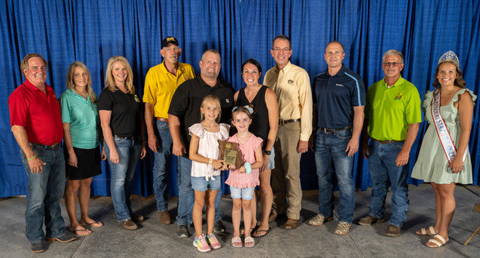 REPRESENTING HENRY COUNTY, Matt and Tabitha Jones, along with Adalynn and Avery (in front center) were recently selected as the Missouri Farm Family for Henry County.  They are show with many dignitaries and representatives at the Missouri State Fair.