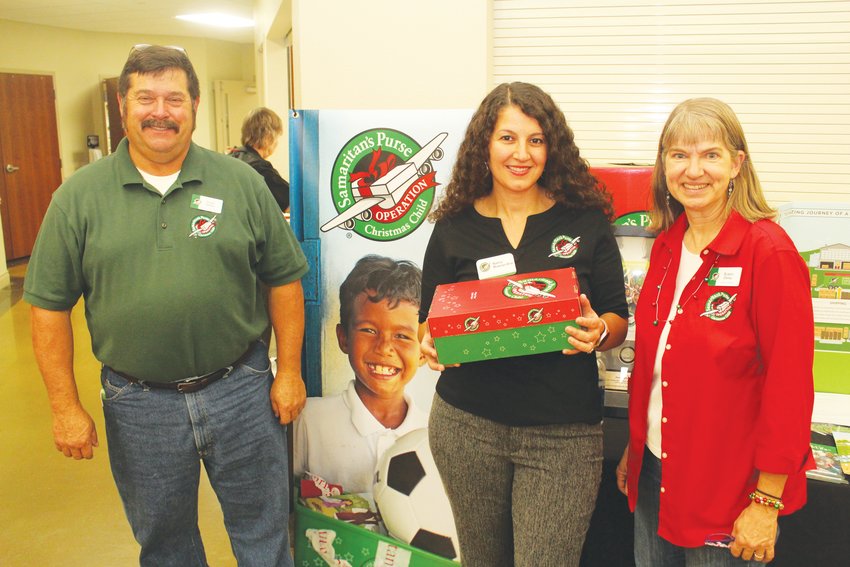 MAKING A BIG IMPACT with the kickoff of Operation Christmas Child were Doyle Oxley,  Nancy Muwanas-Arias and  Susan Oxley at the First Baptist Church in Clinton on Sunday.