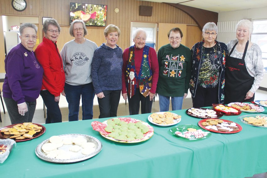 FEEDING BODY AND SOUL for a good cause, Clinton Christian Church volunteers Rita Windburn, Pat Bowse, JoAnne Kemper, Elaine VonSpreckelsen, Annette Myers, Marjory Cooper, Beverly Bowers and Carol Hinton baked thousands of cookies for the church&rsquo;s annual Cookie-Thon.