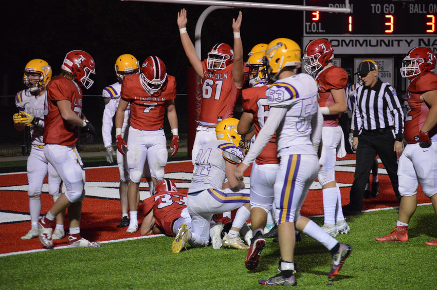 LINCOLN lineman Dallas Drake (#61) signals touchdown as (#33) Ross Johnson powered his way over the goal line in the 48-8 romp of Slater on Friday night in the first round of district play.Lincoln's Kyle Eckhoff (#7) looks on  They host South Callaway this Friday in the second round.