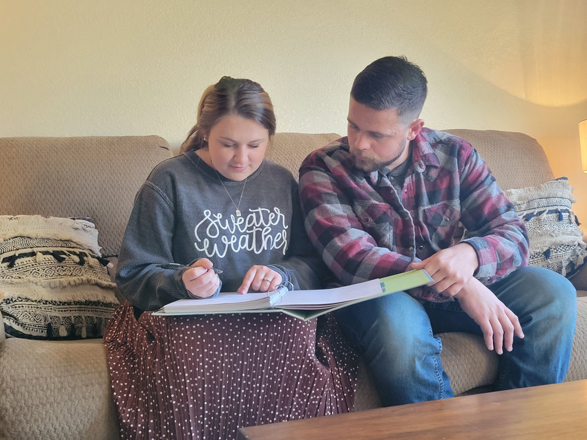 ASSESSING ARRANGEMENTS FOR THEIR UPCOMING CEREMONY, Kylie McRoberts and her fiancee, John Hargrave reviewed final to-do lists before their wedding this weekend.