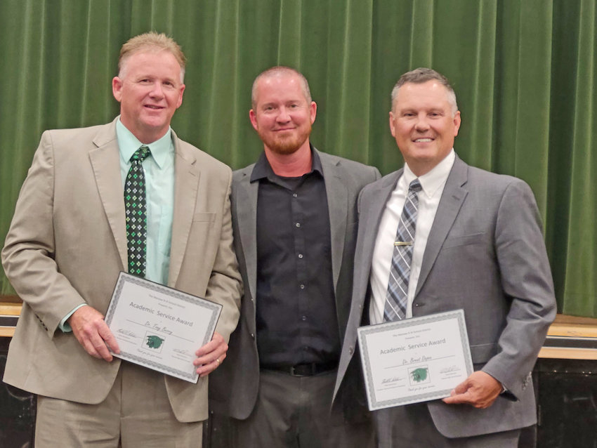 AN EVENING OF EXCELLENCE was on the menu at the annual Warsaw Chamber of Commerce Academic Excellence Banquet on Monday. Dr. Tony Berry (left) and Dr. Brent Depee (right) were recognized for their Academic Service by WHS Principal Danny Morrison. The event was held at in the Warsaw High School gymnasium.