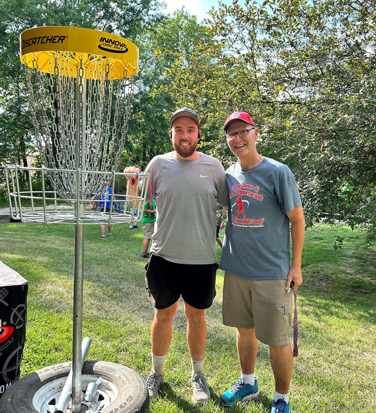 CLINTON'S Tim Komer from the Tony Komer Foundation congratulates Marlin Briggs from Camdenton after winning the grand prize in the raffle during the Olde Glory Days Open held on Saturday, June 24 at Artesian Park.