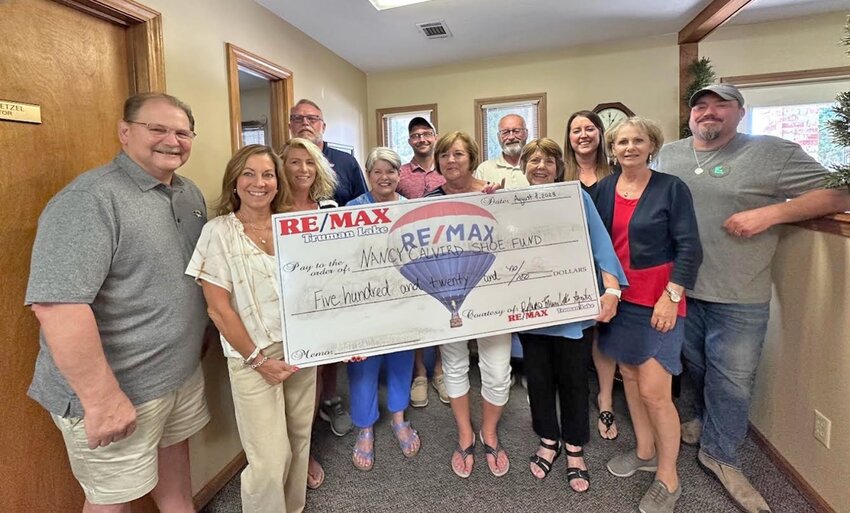 Truman Lake Remax donates to the Nancy Calvird Shoe Fund.