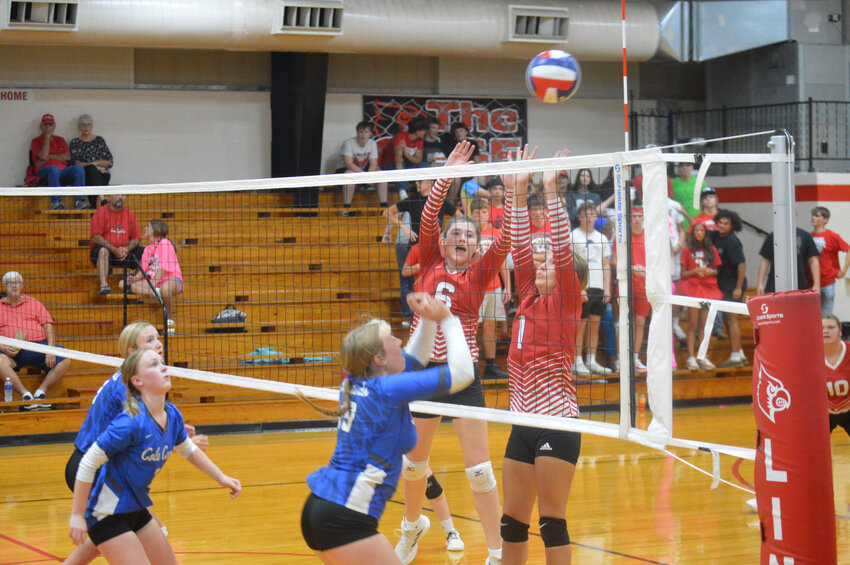 NOT QUITE Lincoln's Camryn Smallwood and Sydney Spry tried to block a return by the Lady Bluebirds, but the shot fell, and so did the Lady Cardinals as Cole Camp won the Benton County duel in straight sets last Tuesday.