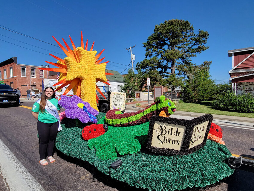 A COLORFUL FLOTILLA was the hallmark of this year's Cole Camp Fair with Trinity Lutheran Church being named the &quot;Grand Champion Float&quot;, as displayed on Saturday by this year's Queen, Ashlyn Russell.