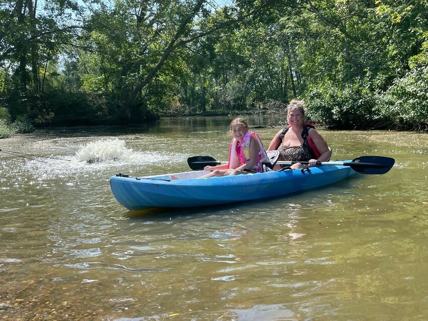 PADDLING THEIR WAY TO LABOR DAY FUN, Aniston and Ally Richardson launched their kayak at Warsaw Adventures on Monday.