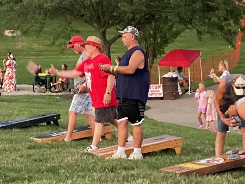 BRINGING THE WOW FACTOR to town, HarborFest will get underway this weekend. Activities will include local residents like Mike Watkins (center)  who participated in last year&rsquo;s Cornhole Tournament.