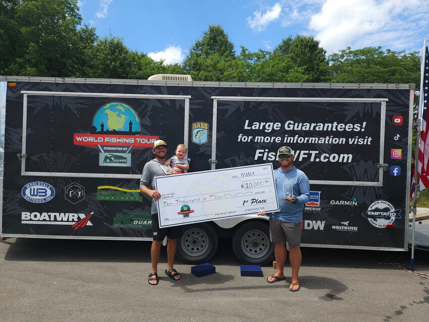 BENDIN' TIPS AND RIPPIN' LIPS, the team of Michael Harlin (right) and Warsaw's Brad Jelinek (left, with son Everett) took first place and cashed a $10,000 check with their finish in the World Fishing Tour stop on Truman Lake on Saturday.  The win qualifies the duo for the organization's season ending championship in October in Oklahoma.