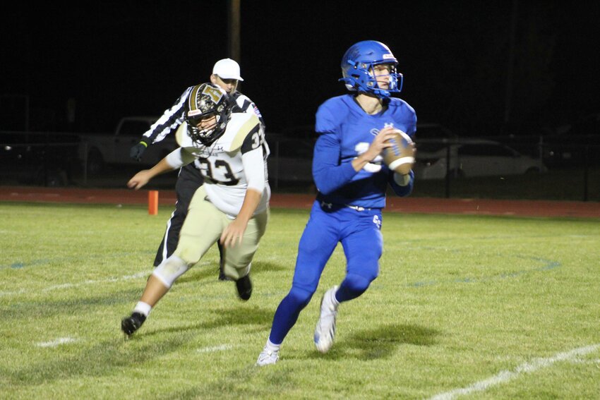 ON THE MOVE, Cole Camp quarterback Gentry Dieckman scrambled to avoid a would-be tackler on Friday night in Cole Camp. Undefeated Adrian dominated Cole Camp in a 55-6 rout.