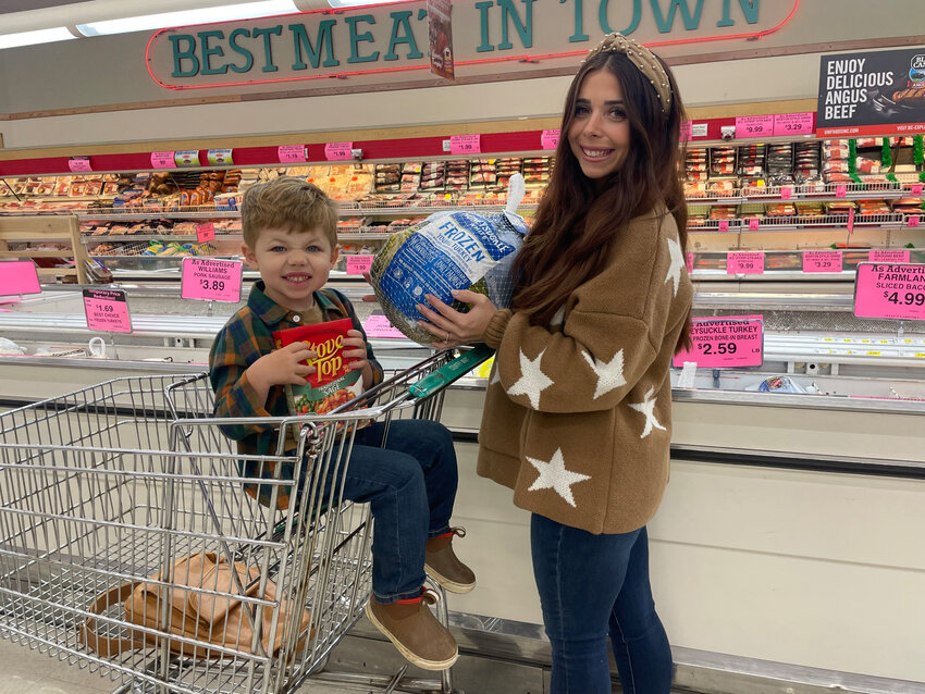 LOOKING FORWARD to a memorable Thanksgiving, Raven Caswell and her son Van shopped for Thursday’s dinner. Caswell said 25 family members will gather at her grandmother’s farm.