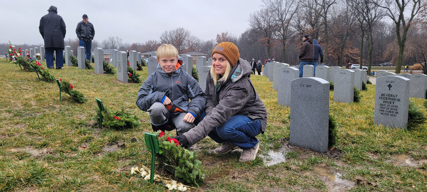 HONORING VETERANS FOR THE HOLIDAYS, Geni Harms and her son, Brycen, 9, participated in the poignant Wreaths Across America program over the weekend.