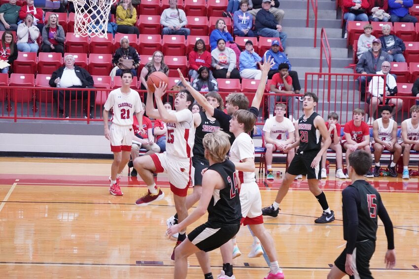 FOLLOWING ANOTHER LOSS to Pleasant Hill last Tuesday night, the Cardinals dropped a close game to Sherwood at home on Monday night, 56-54.  Above, Kaiden Townsend slashed thru the lane for a late basket.