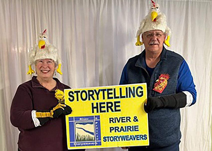 A CLUCKING GOOD TIME will get underway during the 31st Annual Chicken Festival in Clinton January 19-21. Ready for the event are Linda and Gary Kuntz who displayed the RAPS signboard festooned with chicken cheer.