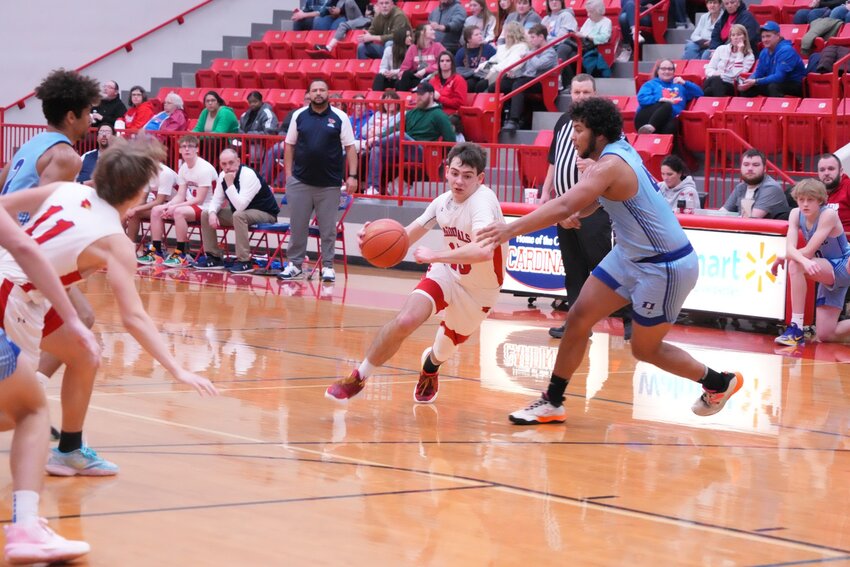 SLASHING THE LANE, the Cardinals' Kaiden Townsend looked to score on the defense of Boonville on Saturday.  Clinton was upended by a final of 58-44, falling to 2-9 on the season.