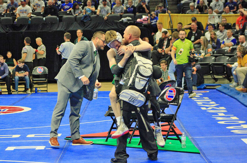 JUMPING FOR JOY, Warsaw's Jayce Estes ended up in the arms of his dad, Lance, after taking first place at the 2024 MSHSAA Wrestling Championships.