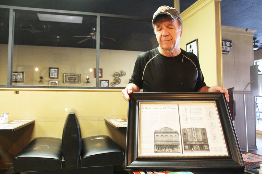 RECALLING THE GOLDEN AGE OF HOLLYWOOD, Square 109 Proprietor Mike Etters shows a photograph of what the building&rsquo;s exterior looked like when it was home to the New Lee Theatre.
