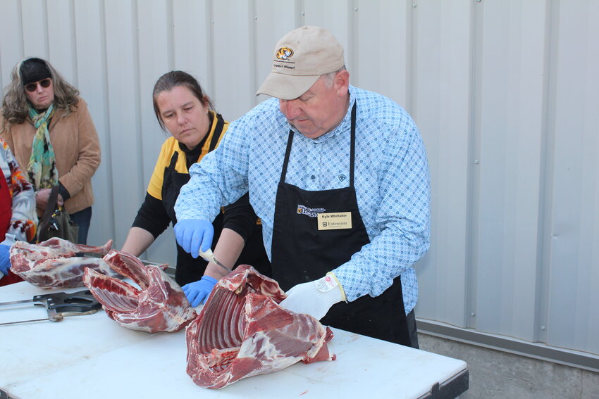 DEMONSTRATING HIS BUTCHERING SKILL, Kyle Whittaker showed Peggy Painter and Jennifer Lutes how to cut up a lamb during the Lamb For Leap Year Workshop in Osceola.