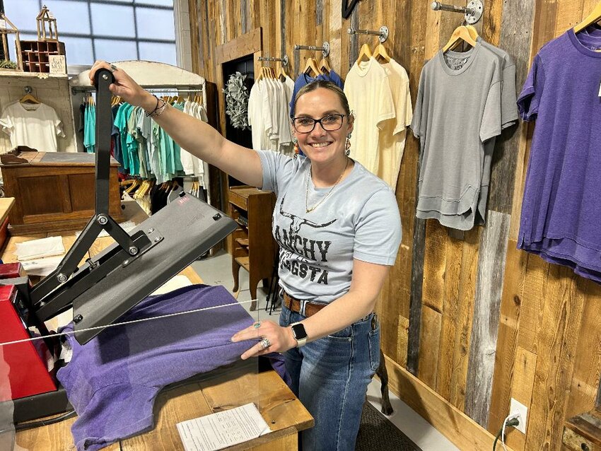 FASHIONISTAS WILL FAN OUT across Benton County this Friday and Saturday during the Spring Boutique Crawl. RiOak Western Design in Cole Camp is among participants. Kelly Humphrey prepared merchandise on Tuesday in preparation for the event.