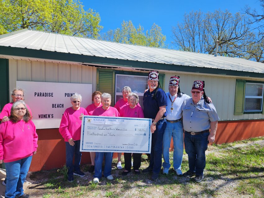 THE WARSAW SHRINE CLUB recently presented the Paradise Point Beach Women's Club with a check for $500.00 as a token of their appreciation for the incredible generosity they have exhibited for years, donating baked goods to so many organizations. Pictured (L to R) front row: Millie Veach Louis, JoAnn Thompson, June Rosier, Debra DeSeure, Steve Elliott. Ron Fountain, John Mackey and back row: Carol Willard, Judy Thompson, Lois Jacobsen.