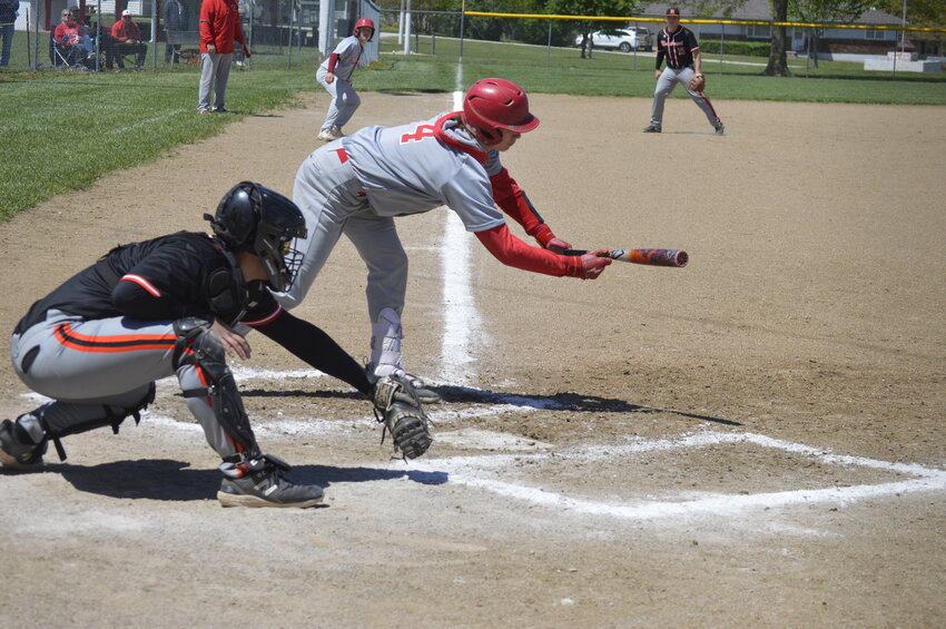 LINCOLN'S Dawson Parrott reaches out to bunt on Saturday against Northwest in a first round game of the Kaysinger Tournament. Lincoln lost a 3-2  heartbreaker.