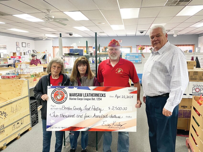 HIGH DEMAND AND LOW INVENTORY continue to strain the Benton County Food Pantry. The organization received a much needed boost from the Warsaw Leathernecks who made a sizable donation. Attending a check presentation were Jeannie Arnold, Susan Sullivan, Eric Kirby and Chuck Allcorn.