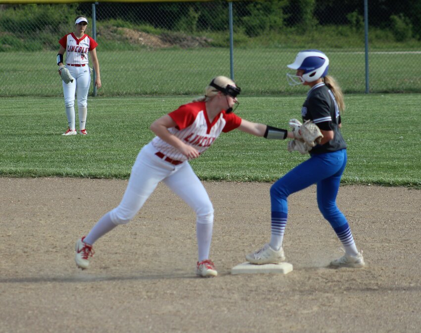 YOU STAY PUT!  Lincoln second baseman Rebekah Helland tags the runner at second keeping her on the bag. Lincoln won the Benton County matchup, 14-2 last Tuesday night in Lincoln.