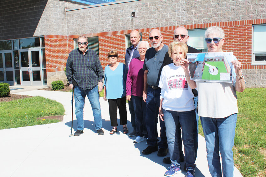 MAKING HISTORY, Linda Wilson holds a picture of Memory Walk pieces that will be installed in front of the current Clinton High School. With Linda is Martha Lowe, G.R. Lowe, Bill Dulaban, Kathy Keith Wood, Dr. Gus Wetzel, Linda Griffiths and Dale Welsh.