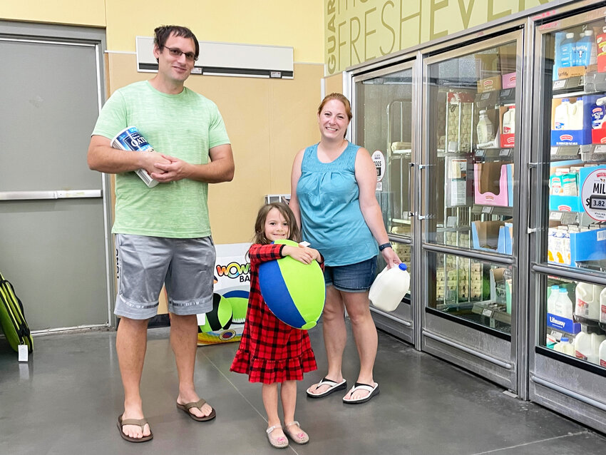 SHARING A SHOPPING EXPERIENCE, Shaun, Hannah and Kiera Green were at Aldi in Clinton on Tuesday morning. A new store is currently under construction and will be located across the street.
