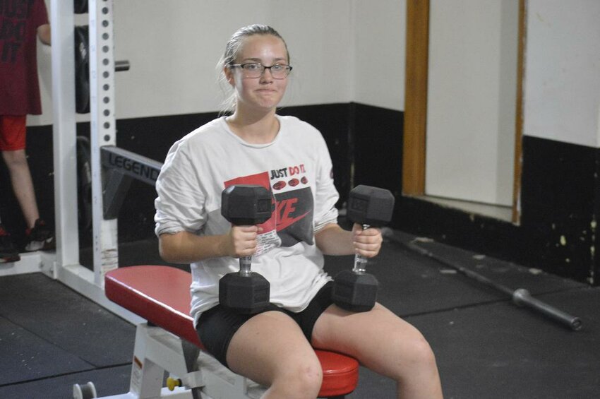 WORKING FOR A SPOT, While rain stopped football practice last week, the Lincoln weight room was alive with middle schoolers. Nevaeh Quick played center on the football team last season, a position she hopes to retain this season. She is the only girl on the team.