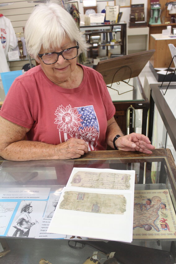 PART OF THE DISTANT PAST, Patty Bartz looks at a replica of the receipt Cole Younger signed when he bought a horse from her great-great-grandfather. The document is housed in the Appleton City Museum.